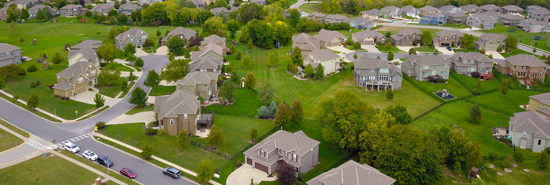 Shingle roofs across a suburb, seen from a drone